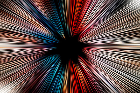 Abstract radial zoom blur surface of in blue, orange and red tones on a black background. Spectacular background with radial, radiating, converging lines.