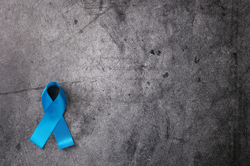Close-up of  blue ribbon international symbol on abstract dark background.