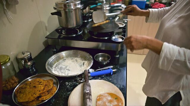 Cooking Indian Flat breads in Kitchen
