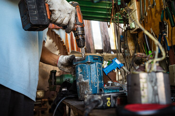 Mechanical man hand working fix electric drill motor roter