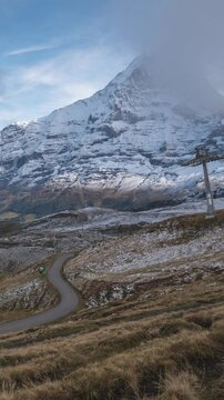 Nature landscape time lapse of Swiss Alps mountain range at Eiger peak and Mannlichen cable car (Vertical)
