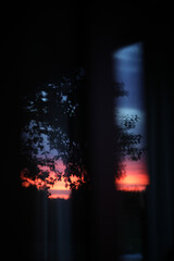 Sunset clouds mirrored in the window. Nature sunset sky backdrop. Blurry abstract sunrise background
