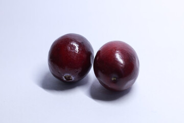 red cranberries on white background, macro shot	