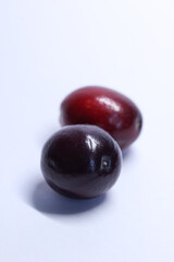 red cranberries on white background, macro shot