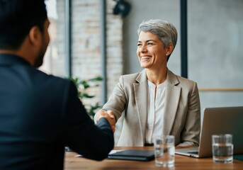 Businesswoman shaking hands with a client at a meeting