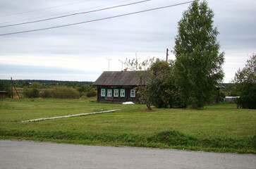 Wooden country house, russian village, field.