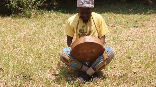 Man Playing the Mbira also called Thumb Piano, Kalimba or Sansa