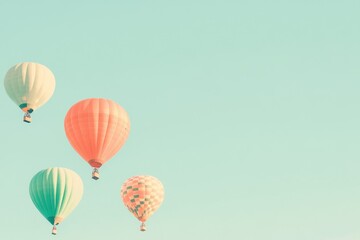 Fototapeta premium A set of brightly colored hot air balloons rising into a clear sky. 