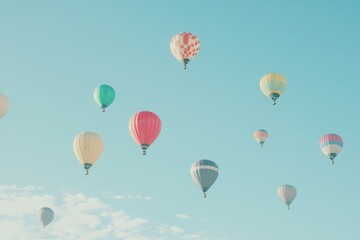 Naklejka premium A set of brightly colored hot air balloons rising into a clear sky. 