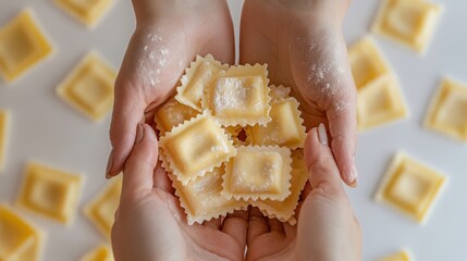 Hands carefully holding freshly cut ravioli, each square