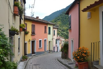 A street in a small Italian village lined with brightly painted houses in various shades of yellow, pink, and orange.