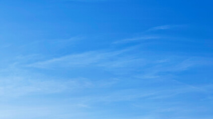 Blue sky with white clouds The sky was clear and bright with clouds scattered throughout the sky. The scene is calm and peaceful with happiness.
