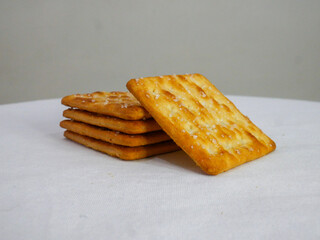 Stack of butter cracker on white table and grey backgound