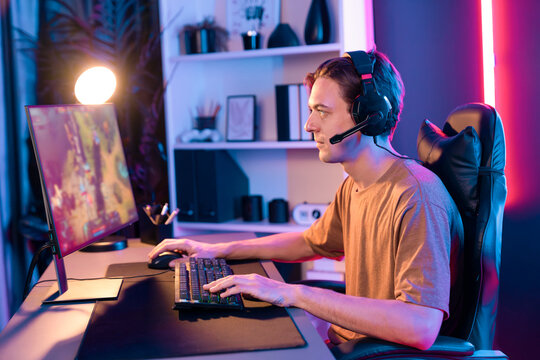 Host channel concentrated smart gaming streamer playing the fighting Moba on computer screen with muptiplayers or single at battle arena . Esport live streaming at neon digital light room. Pecuniary.