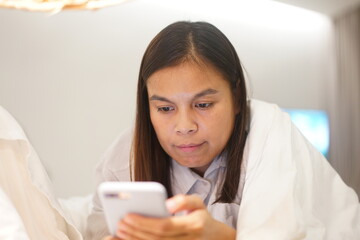 Beautiful happy young woman with mobile sitting and smiling, online dating concept.