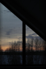 Fototapeta premium Sunset clouds mirrored in the window. Nature sunset sky backdrop. Blurry abstract sunrise background