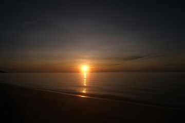 The sun rises at the sea in the morning.