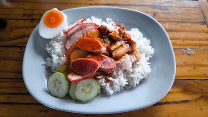Red pork and crispy pork on rice, food in Thailand.