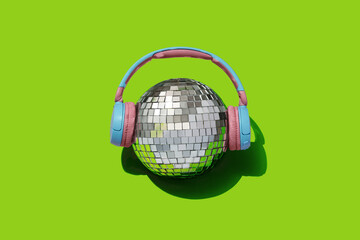 disco ball and headphones on pink backgournd. Concept for party and celebration