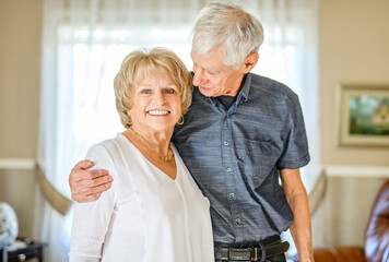 elderly 80s couple embracing each other at home