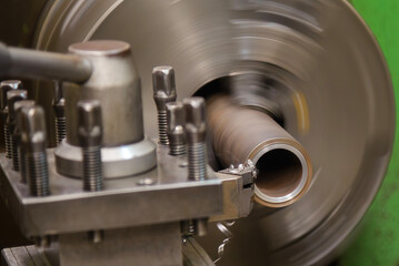 The lathe machine finish cut the metal shaft parts by lathe tools.