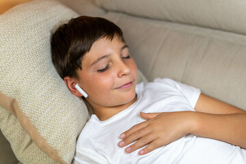 Close-up portrait of relaxed boy listening to his favorite playlist