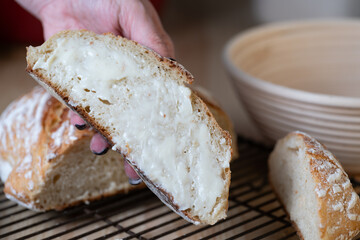 Woman's Hand Holding a Slice of Fresh Baked Bread