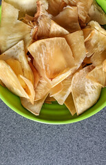 Keripik sukun is chips which made of deep fried thin slice breadfruit. Crispy savory snack. Typical Indonesian traditional chips. Selective focus