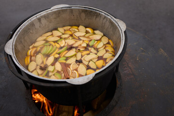 The Glow of Embers and Flames in a Steel Cooking Pot Outdoors Under the Starry Sky