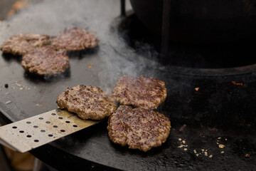 Sizzling, Mouthwatering Burgers Cooking Perfectly on a Griddle at a Summer BBQ Event