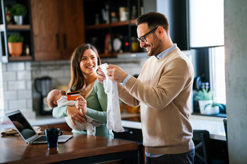 Parents with baby having video call online, conversation with relatives, communicating with friends