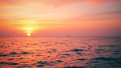 Obraz premium A Blurred View of the Horizon at Sunset, with the Sun and the Clouds Reflecting in the Rippling Water