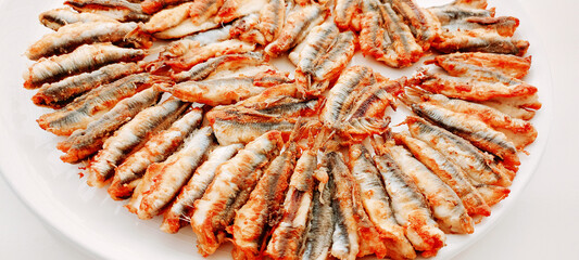 fried anchovies in a frying pan, fried anchovies (TURKEY anchovies), anchovy fish, fried anchovies in a salad plate, collage from different photos of delicious seafood