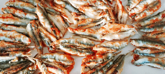 fried anchovies in a frying pan, fried anchovies (TURKEY anchovies), anchovy fish, fried anchovies in a salad plate, collage from different photos of delicious seafood