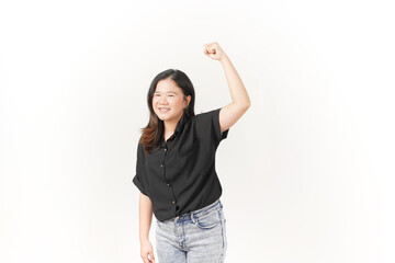 Obraz premium beautiful Asian woman displays a joyful expression, raising her hand in a celebratory gesture against a white background