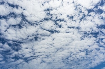 Many clouds on a bright blue sky background in a beautiful day