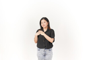 beautiful Asian woman places her hand gently on her chest, expressing sincerity or gratitude,...
