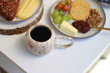 Assortment of various breakfast foods and drinks on the white table. Selective focus.