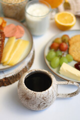 Assortment of various breakfast foods and drinks on the white table. Selective focus.