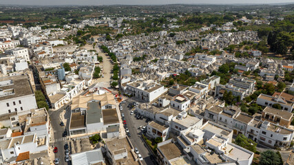 Aerial view of the Trulli in the historic center of Alberobello, in the metropolitan city of Bari, Puglia, Italy. They are ancient traditional white houses with a conical roof. Apulian panorama.