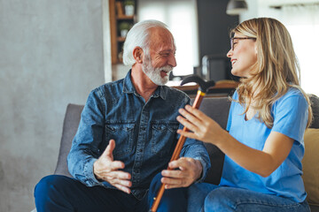 Smiling Senior Man and Caregiver in a Happy Conversation