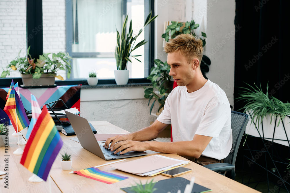 Wall mural young blonde man in casual attire working in office.