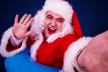 Vacation and Holidays. Funny Drag Queen in Santa Claus costume.