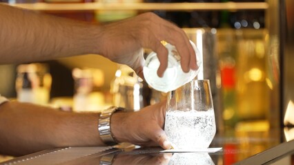 Closeup bartender hand in poring fresh soda gas texture into glass of drink advertisement serving customer at beverage bar counter luxury pub for welcome impression greeting guess service. Vinosity.