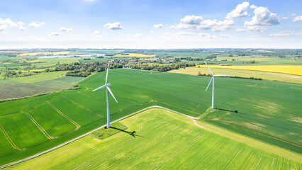 Wind turbines that produce electricity, built on a field in Skanderborg, Denmark