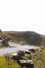 Couple walking. Landscape with rocks and sea.