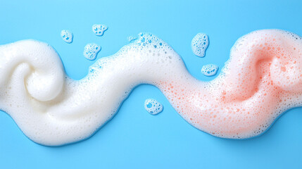 Obraz premium Swirling foam in white and pink colors on blue background creates playful scene