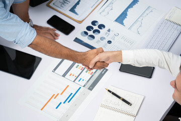 Diverse group of office employee worker shake hand after making agreement on strategic business...