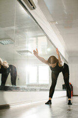 Reflection of a Contemporary Dancer Practicing Beside the Studio Mirror