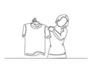 Continuous one line drawing of woman holding clothes on hangers. Shop assistant holding hangers with clothes single line draw vector illustration. Editable vector.